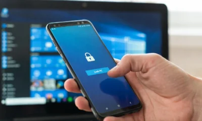 Android Phone Link Lock PC button mid-tap with laptop in background