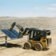physical AI robot arm automating solar farm construction site